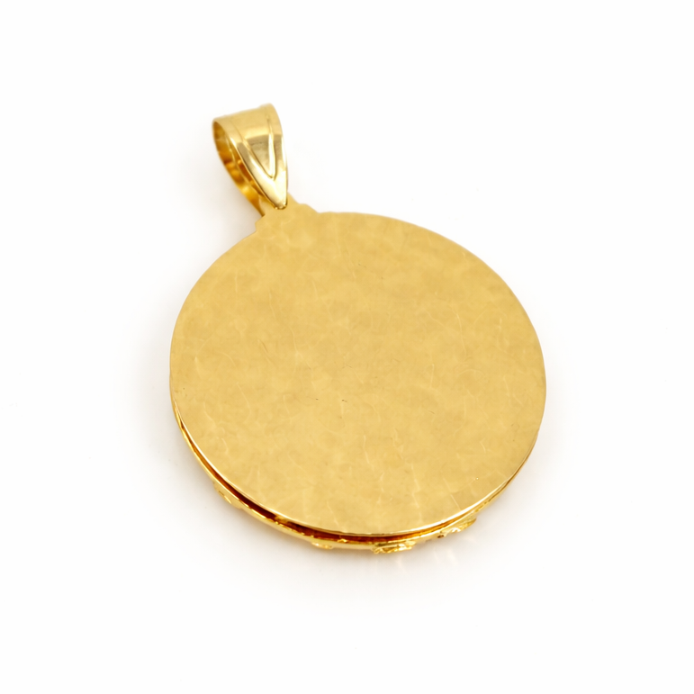 Detail view of religious gold pendant at Mayra Jewelry