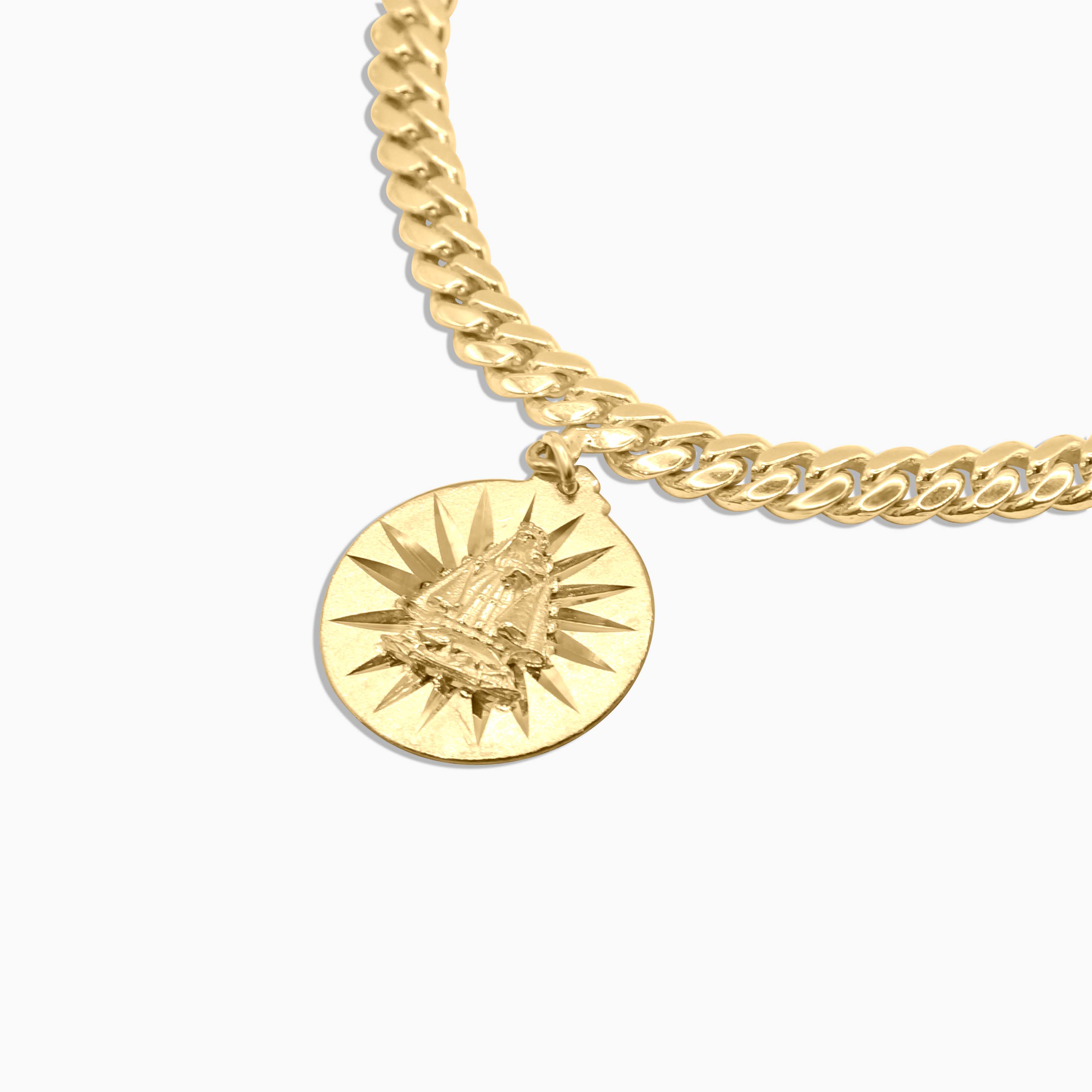 Close-up of gold bracelet with sunburst medallion charms at Mayra Jewelry
